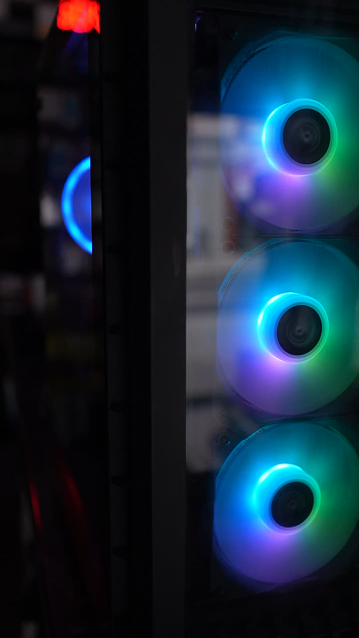 Close-up of three teal RGB intake fans on a custom PC